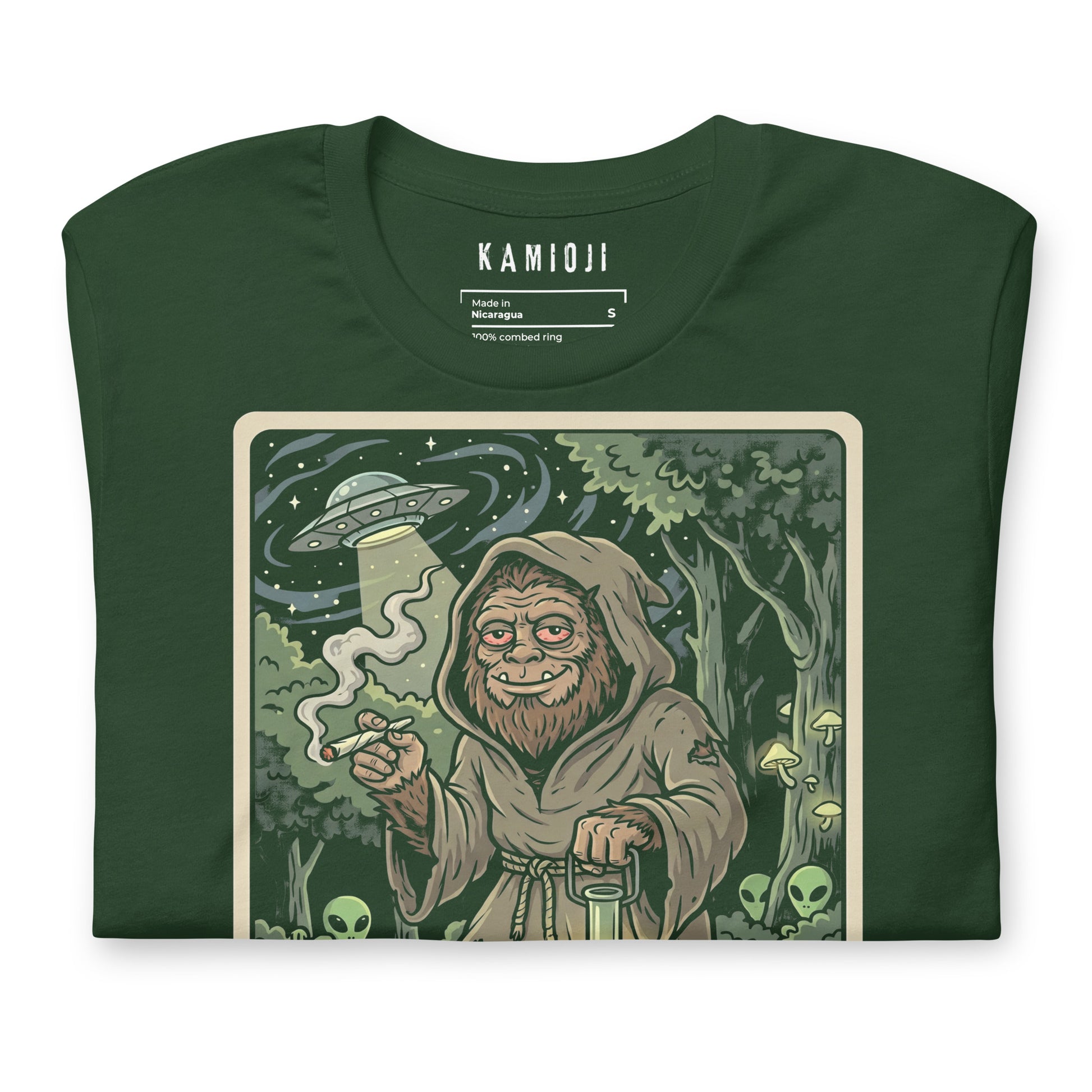 tarot illustration of 'The Hermit' featuring Bigfoot, glowing mushrooms, and aliens, with "KAMIOJI" brand details in the corner.