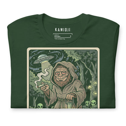 tarot illustration of 'The Hermit' featuring Bigfoot, glowing mushrooms, and aliens, with "KAMIOJI" brand details in the corner.