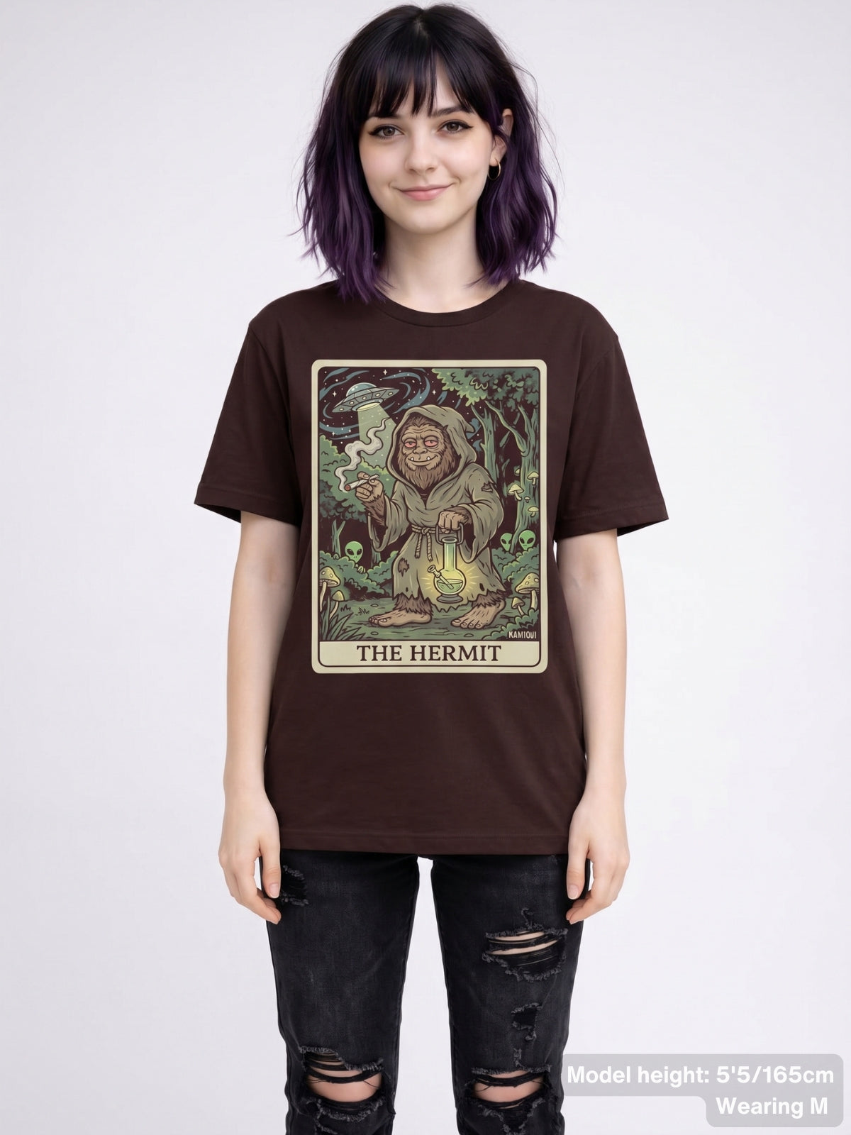 Funny cryptid streetwear shirt displaying a detailed illustration of a smoking Bigfoot as 'The Hermit' with psychedelic forest details.