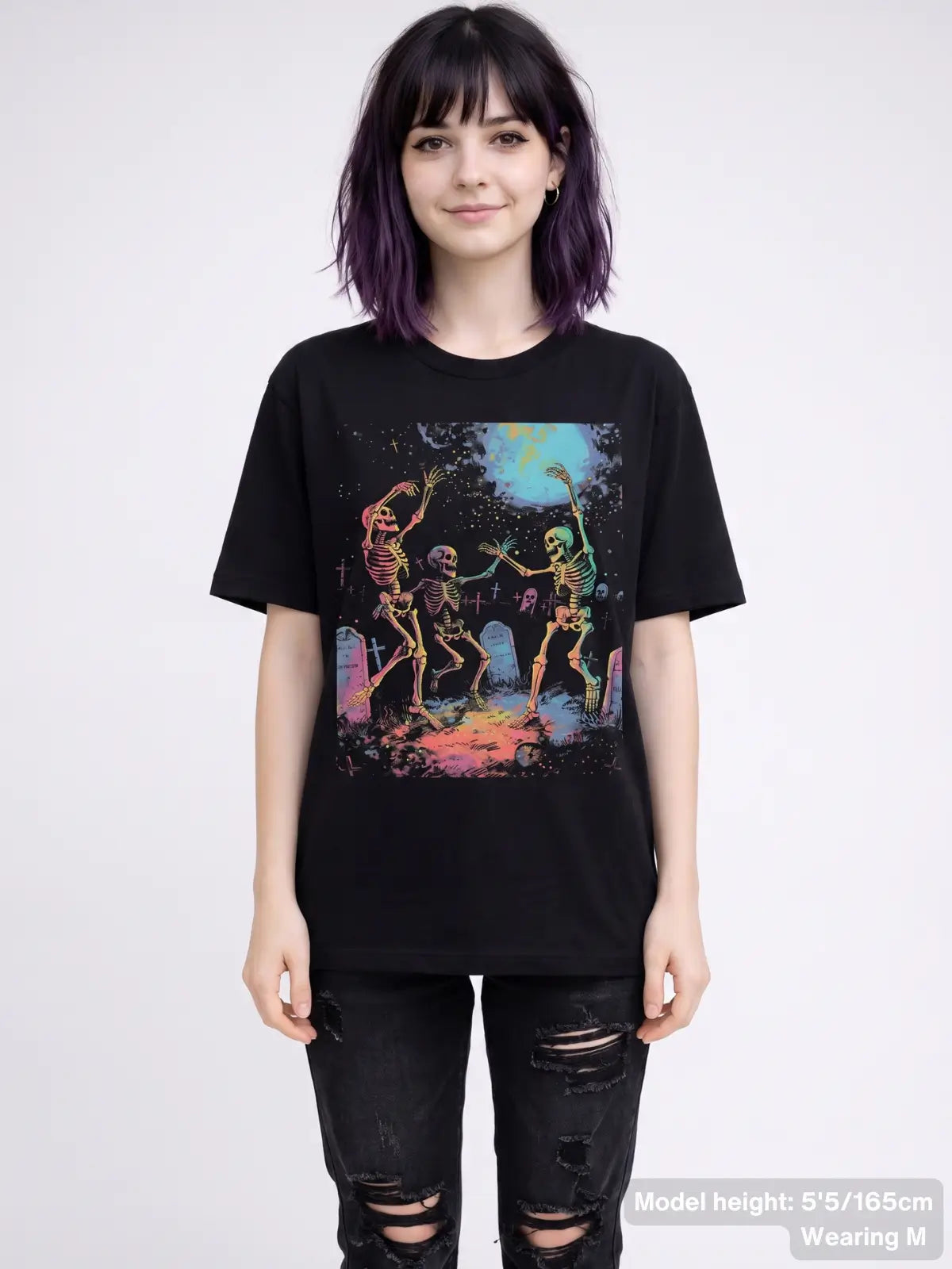 Dancing skeleton graphic tee featuring three skeletons celebrating in a graveyard beneath a full moon with tombstones and spooky artwork. | Colour: Black