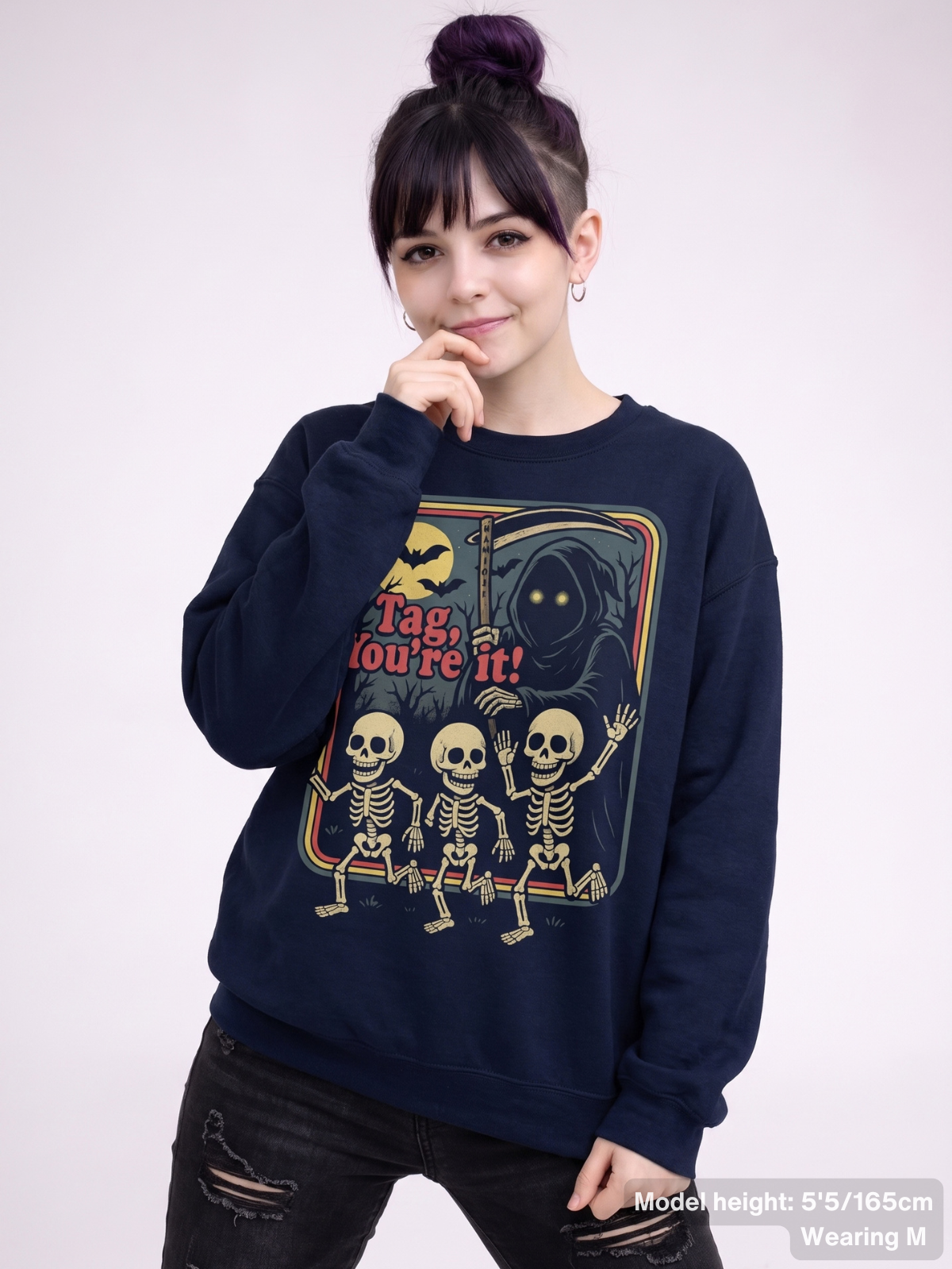 Female model wearing the KAMIOJI Tag You’re It skeleton Halloween graphic sweatshirt | Colour: Navy