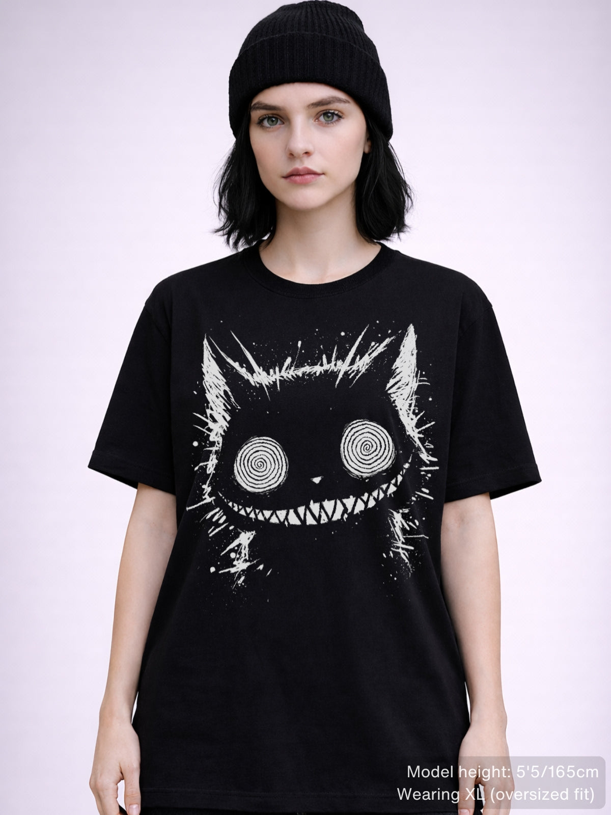Gothic alternative tee showcasing eerie Cheshire Cat artwork with hypnotic eyes and distorted smile
