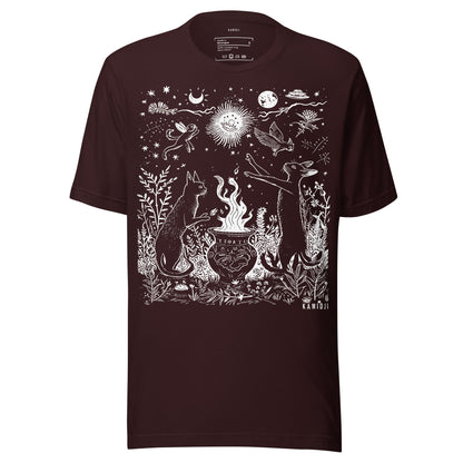 Graphic t shirt featuring intricate line art of cats, a cauldron, and night sky symbols including moons, stars, and a radiant sun. Oxblood black.